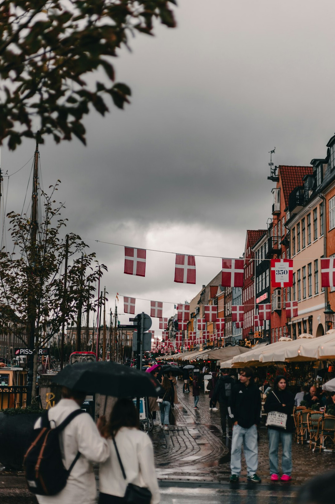 People queuing at a bus stop in the rain in Denmark